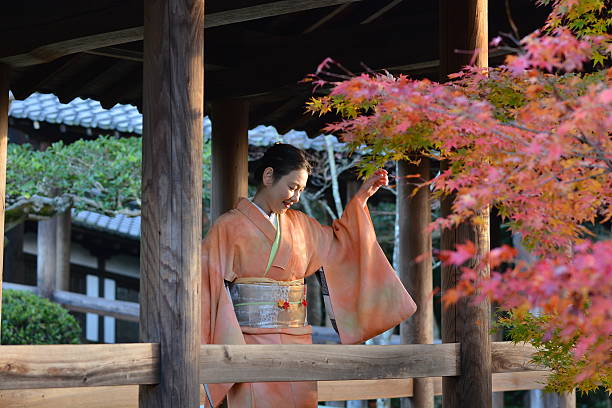 Japanese woman in kimono watching fallen leaves at Tofuku-ji Temple stock photo