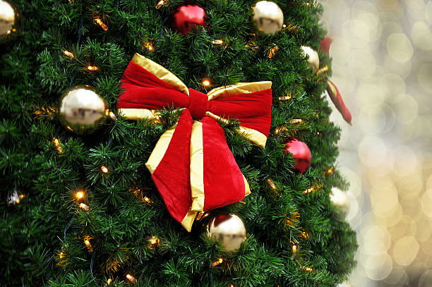 istock Beatiful Christmas tree with large red ribbon 629368706