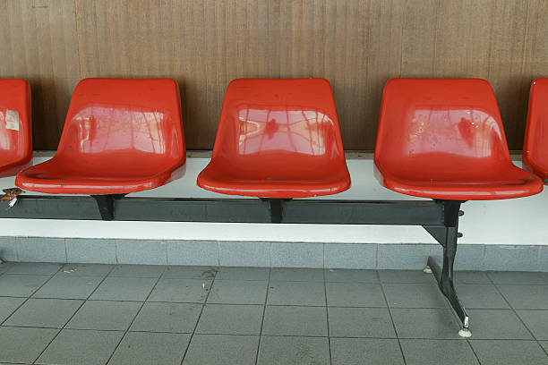 istock Row red chair on the wall 629369430