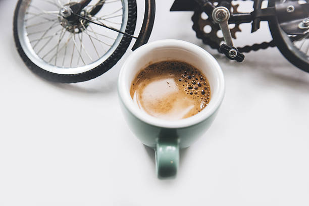 Coffee beans and fresh espresso coffee and a miniature bicycle