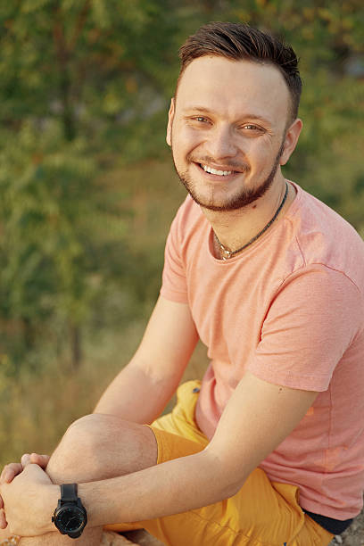 istock Young man smiling and enjoying sunny summer day 629375176