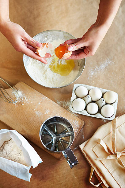 istock Braking eggs into the mixing bowl 629375260