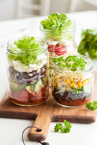 healthy vegetable cheese salad in mason jars