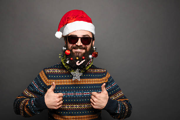 istock Bearded male in santa hat shows thumbs up. 629376534