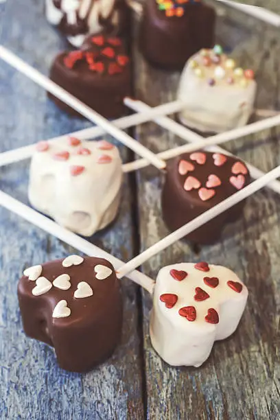 Photo of Cake pops with heart-shaped bitten off close-up