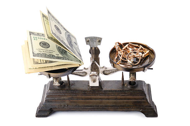 istock scales, money and gold isolated on white 629382024