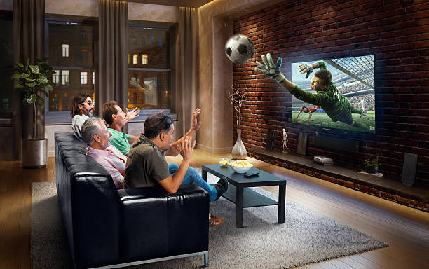 istock Adults watching Soccer game at home 629385114