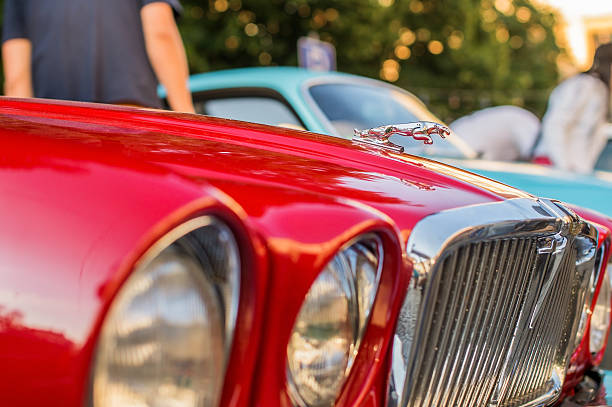 Bridlington, England - June 12, 2011: Close up details of a red vintage 3.8 litre Jaguar car, with the iconic leaping jaguar mascot.