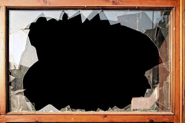 istock broken window glass detail 629387368