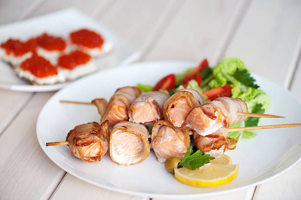 istock Roasted salmon meat pieces wrapped in bacon slices 629389956