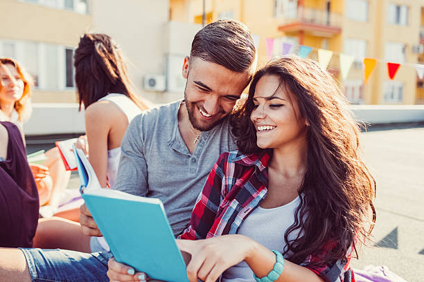 Young couple studying on rooftop terrace