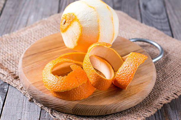 peeled orange on the wooden background A peeled orange on the wooden background peel plant part stock pictures, royalty-free photos & images