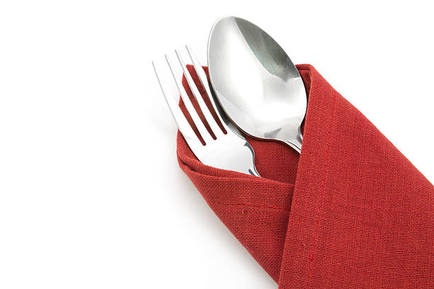 fork and knife on red napkin isolated on white background.