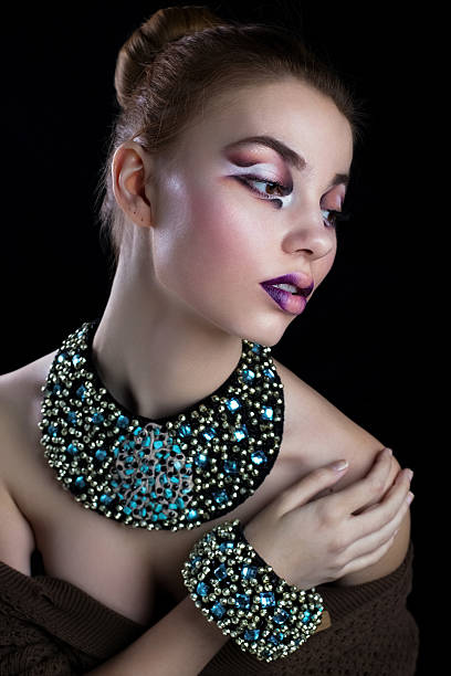 istock Pretty woman model face with artistic make up and necklace 629404212