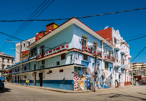 Havana, Сuba - October 13, 2016: Large intersection with apartment building facade, overlooking Callejon De Hamel Avenue in old Havana. Abstract style graffiti on the walls. Envisioned as artist colony and display, this community features eclectic art work inspired by Santeria religion. 