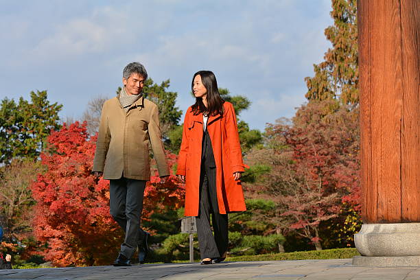 Japanese couple in their 40s enjoy talking at Tofuku-ji Temple stock photo
