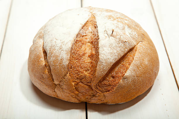 istock Bread on a white wooden background 629406944