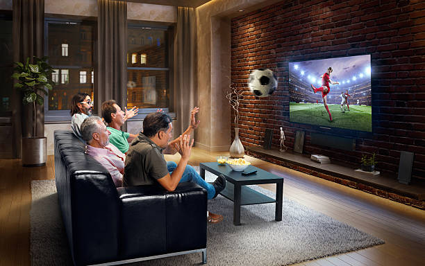 istock Adults watching Soccer game at home 629407024
