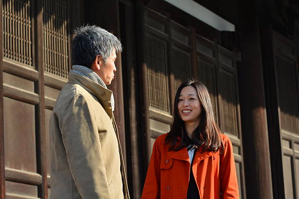 Japanese couple in their 40s enjoy talking at Tofuku-ji Temple stock photo