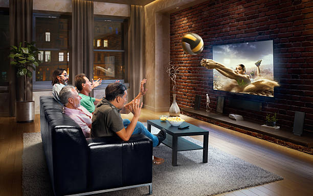 istock Adults watching Volleyball game at home 629407436