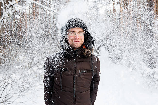 istock Man in fur winter hat with ear flaps smiling portrait 629412724