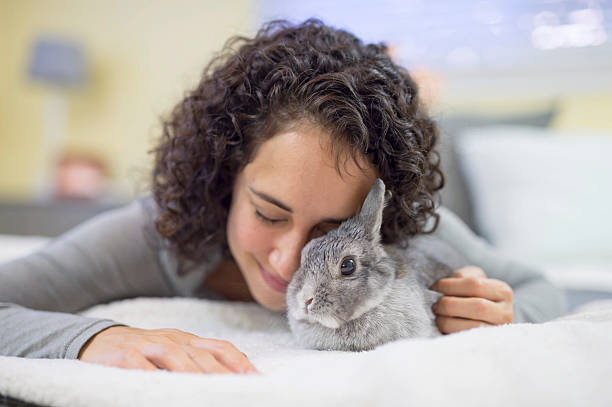 istock Hispanic adult female struggling with a bunny  rabbit 629413486