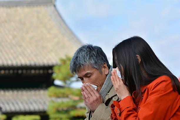 Japanese couple in their 40s sneezing at Tofuku-ji Temple stock photo