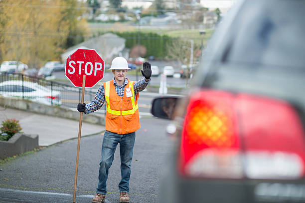 istock Adult male construction worker stopping traffic 629420146