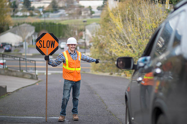 istock Adult male construction worker directing traffic 629420148