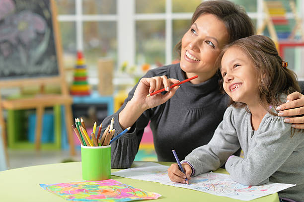 istock Mother and daughter drawing 629420412