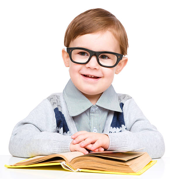 istock Little child play with book 629420454