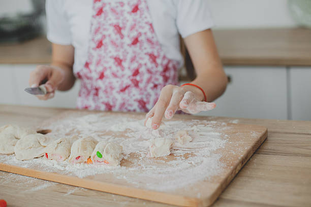 istock Mother with her daughter are preparing the buns 629421194