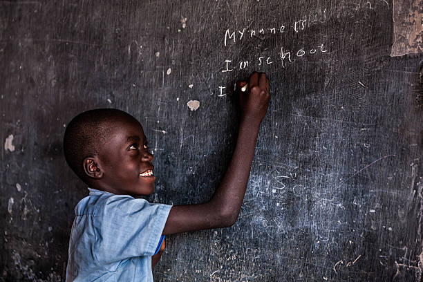istock African young boy is learning English language, orphanage in Kenya 629421876