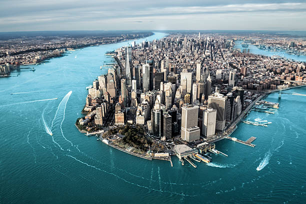 Aerial view of Manhattan island Helicopter point of view of Manhattan island in New York City. lower manhattan stock pictures, royalty-free photos & images
