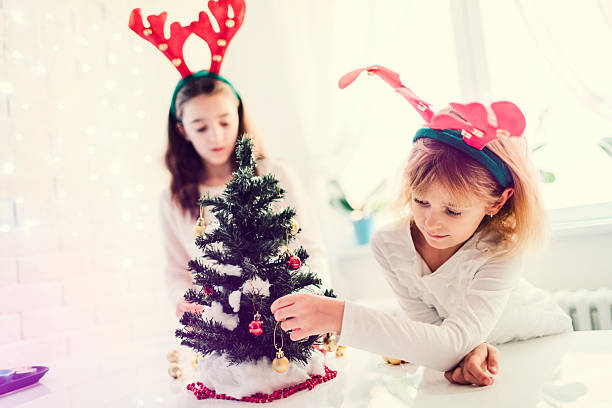 istock Girls Decorating Christmas Tree 629427720