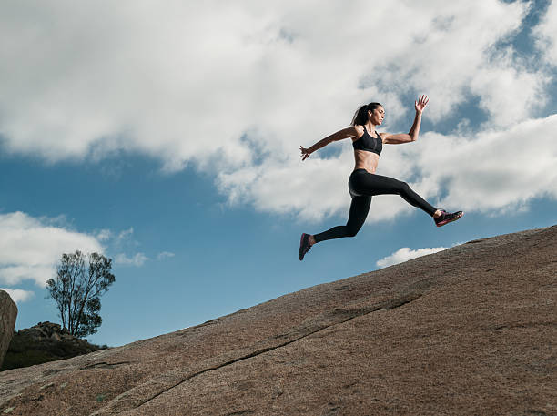 istock Hispanic Women Running Up A Granite Boulder 629429270