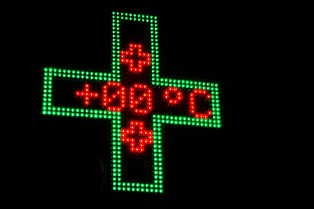 istock Illuminated Green and Red neon Pharmacy sign displaying temperature 629429280