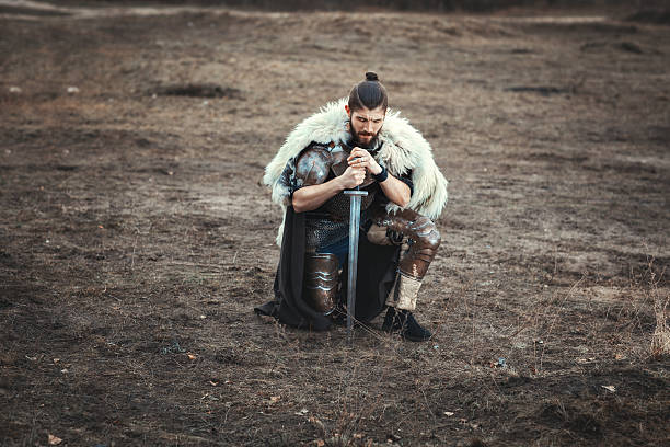istock Formidable man with a sword in field sad. 629429808