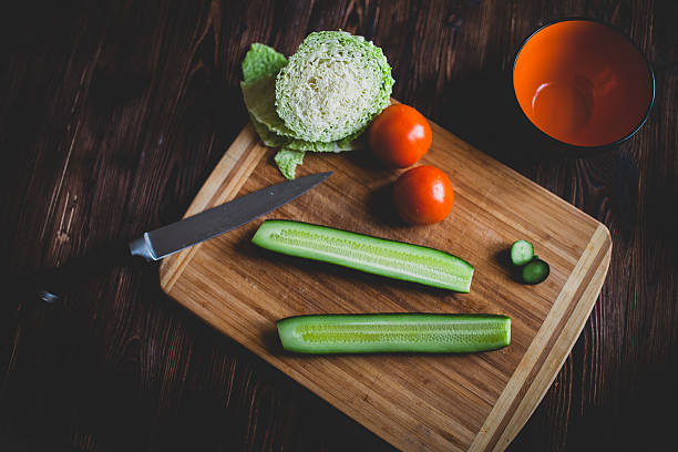 Сucumbers and tomatos on the cooking board stock photo