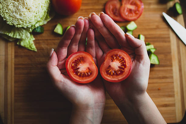 tomatos on hands stock photo