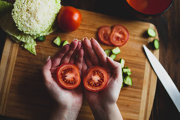 tomatos on hands stock photo