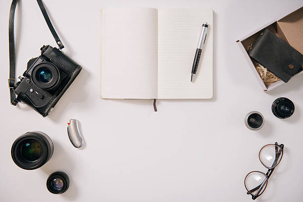istock Open notebook being surrounded by photography equipment 629431438