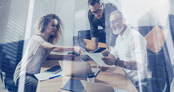 istock Double exposure concept.Young team of business partners making great 629432316