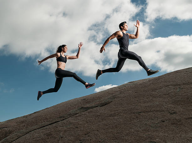 istock Hispanic Man and Women Running Up A Granite Boulder 629433626