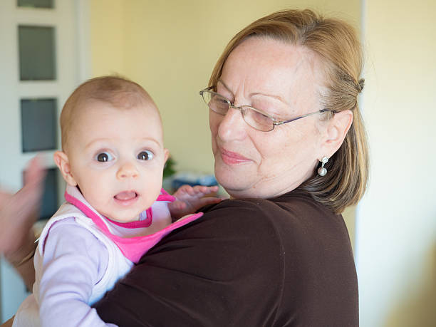 istock Baby held by her grandmother 629440942
