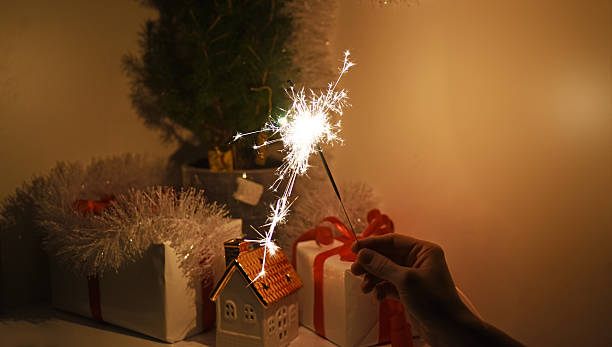 Christmas sparklers in darkness. New Year decorations on background.
