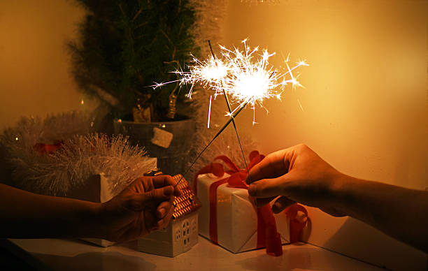 istock Christmas sparklers in darkness. New Year decorations on background. 629441460