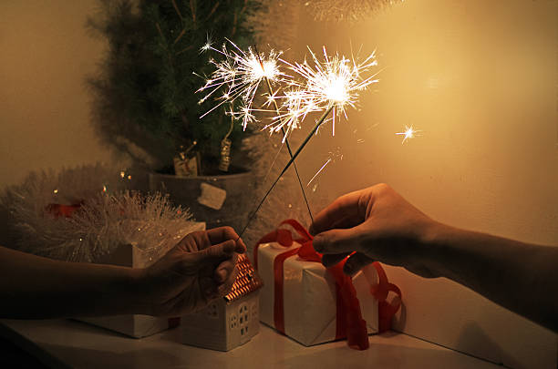 istock Christmas sparklers in darkness. New Year decorations on background. 629441556