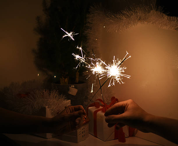 istock Christmas sparklers in darkness. New Year decorations on background. 629441740