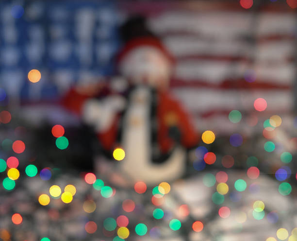 Festive all American holiday background with twinkling lights and a snaoman.